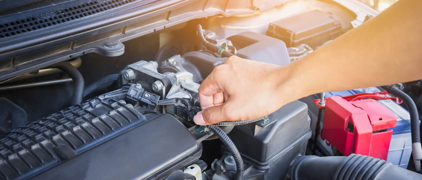 Technician working on car engine