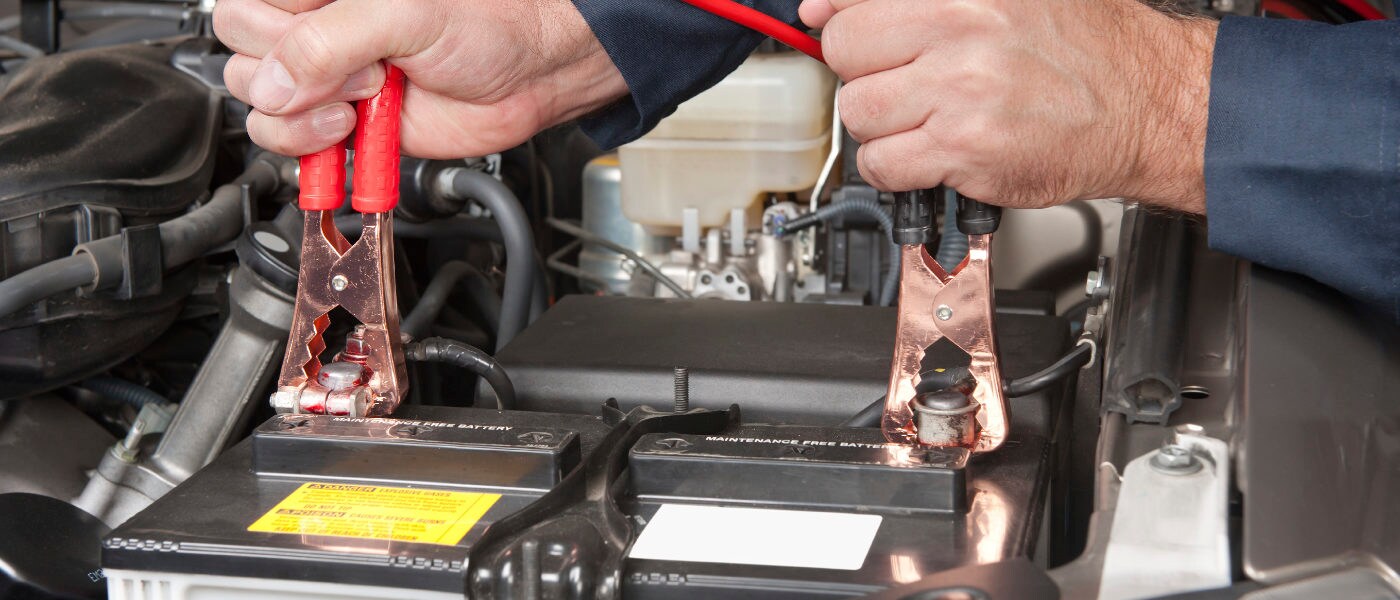 Technician working on car battery