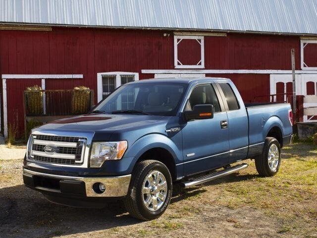 2013 Ford F-150 extended cab pick up truck blue in front of barn.jpg