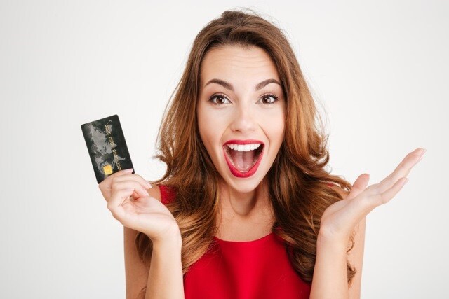 Credit-Card-Girl-Website.jpeg Happy woman holding a credit card that she can use to pay for her service and parts. Service financing available at Speck Chrysler Jeep Dodge Ram