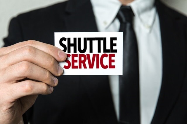 shuttle-service-speck-hyundai-pasco.jpeg Man holding a shuttle service sign