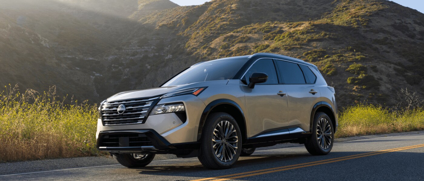 2025 Nissan Rogue Exterior Driving By Grassy Hills