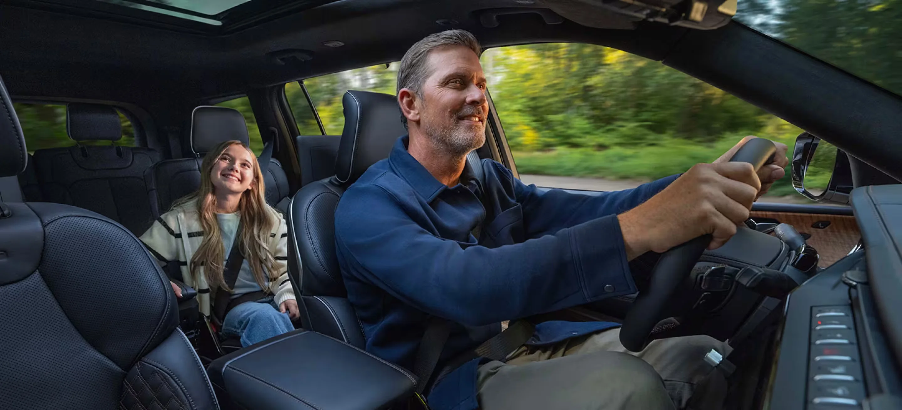 Father driving 2026 Grand Cherokee with daughter in rear seat