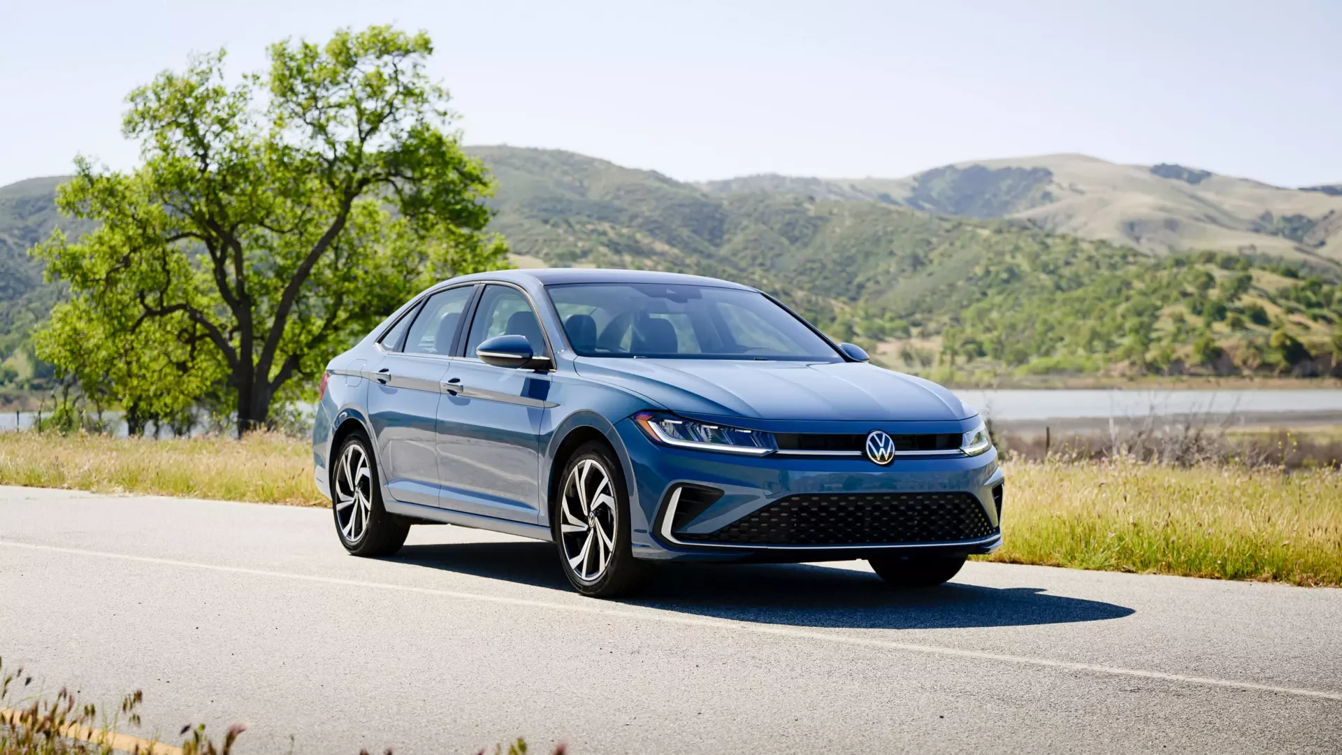 2026 Volkswagen Jetta front three quarter view in blue, parked on an open road, at Sport Durst Volkswagen of Jacksonville NC