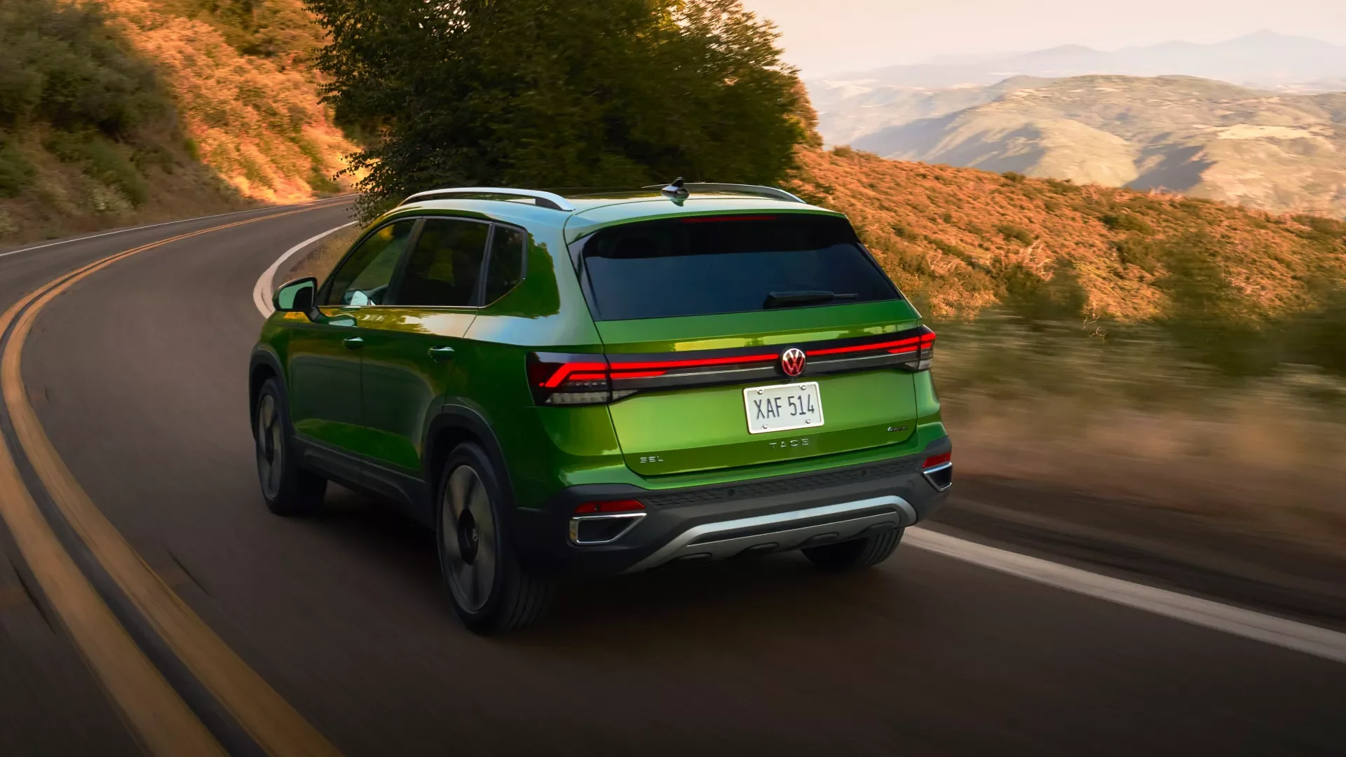 2026 Volkswagen Taos exterior, rear view driving on North Carolina highway