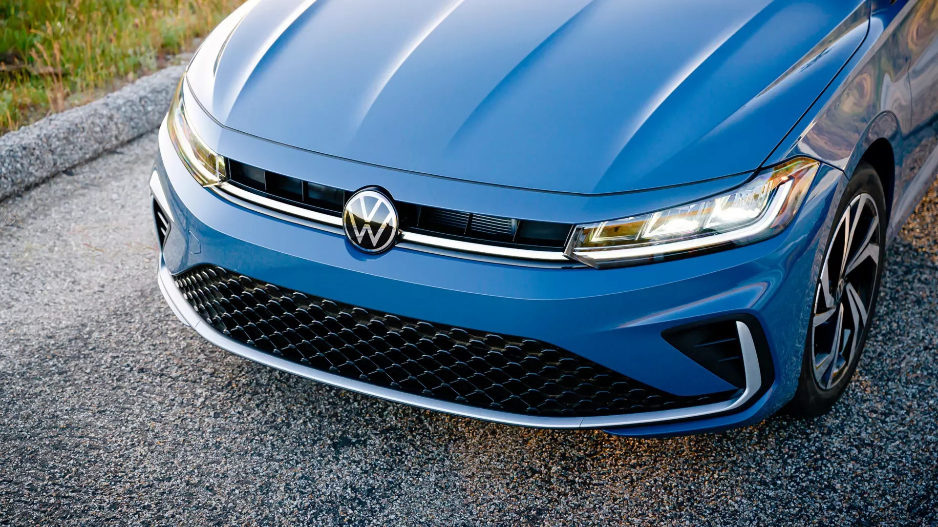 Close up of a Volkswagen Jetta front end showing the grille, VW badge and headlight, the kind of detail a used car inspection covers