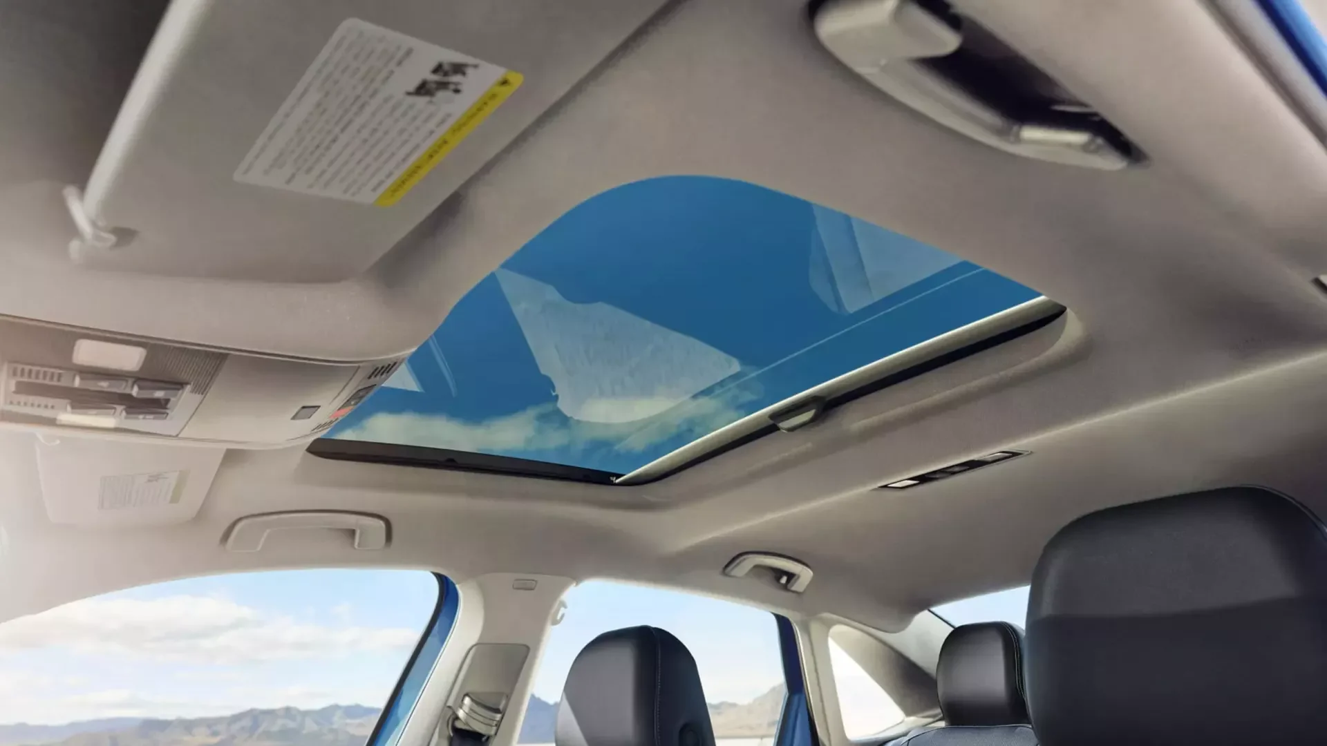 Looking up through the panoramic sunroof of a 2026 Volkswagen Jetta, standard on the SE trim