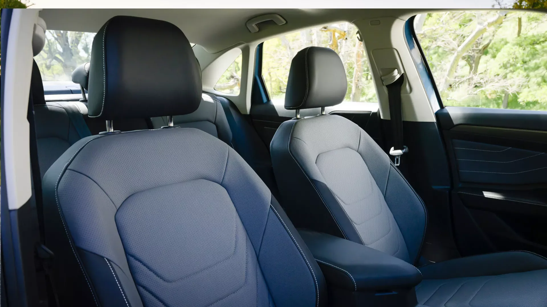 Front seats inside a 2026 Volkswagen Jetta, a five-seat compact sedan for young Jacksonville NC families
