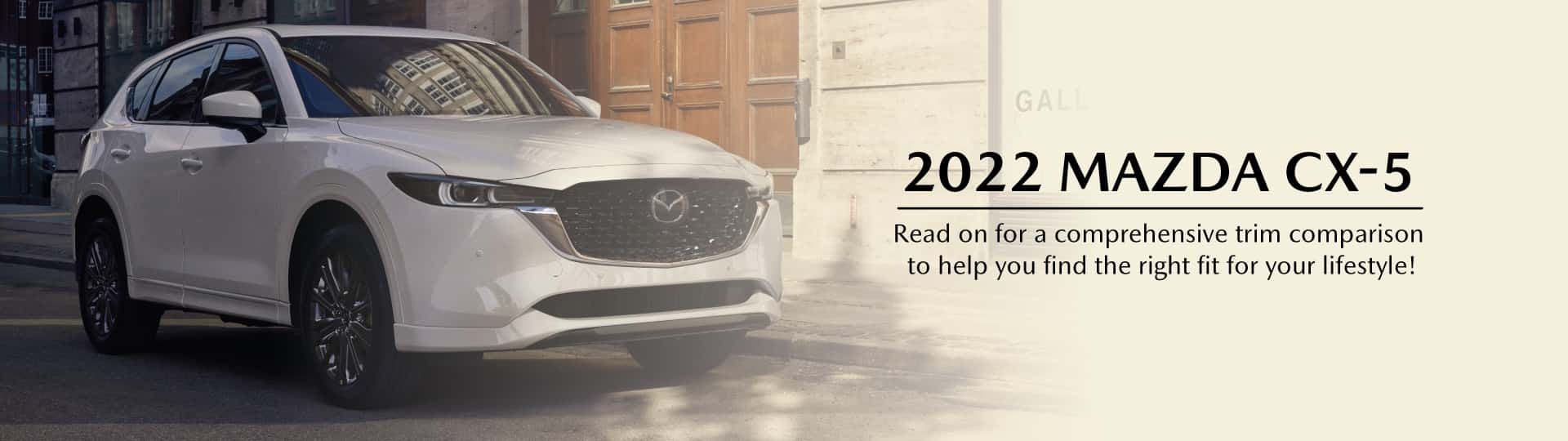 A white Mazda CX-5 Signature on an empty city street