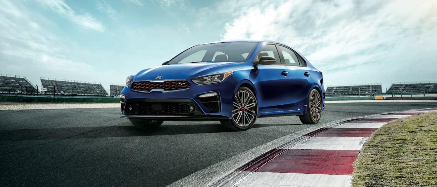 A blue 2020 Kia Forte parked on an empty racetrack