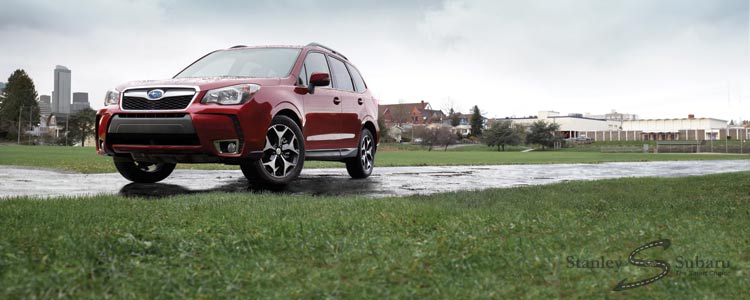 2016 Forester on wet pavement with a field
and a low skyline in the background