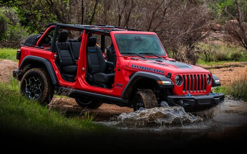 Jeep Rubicon 4xe driving through river trail