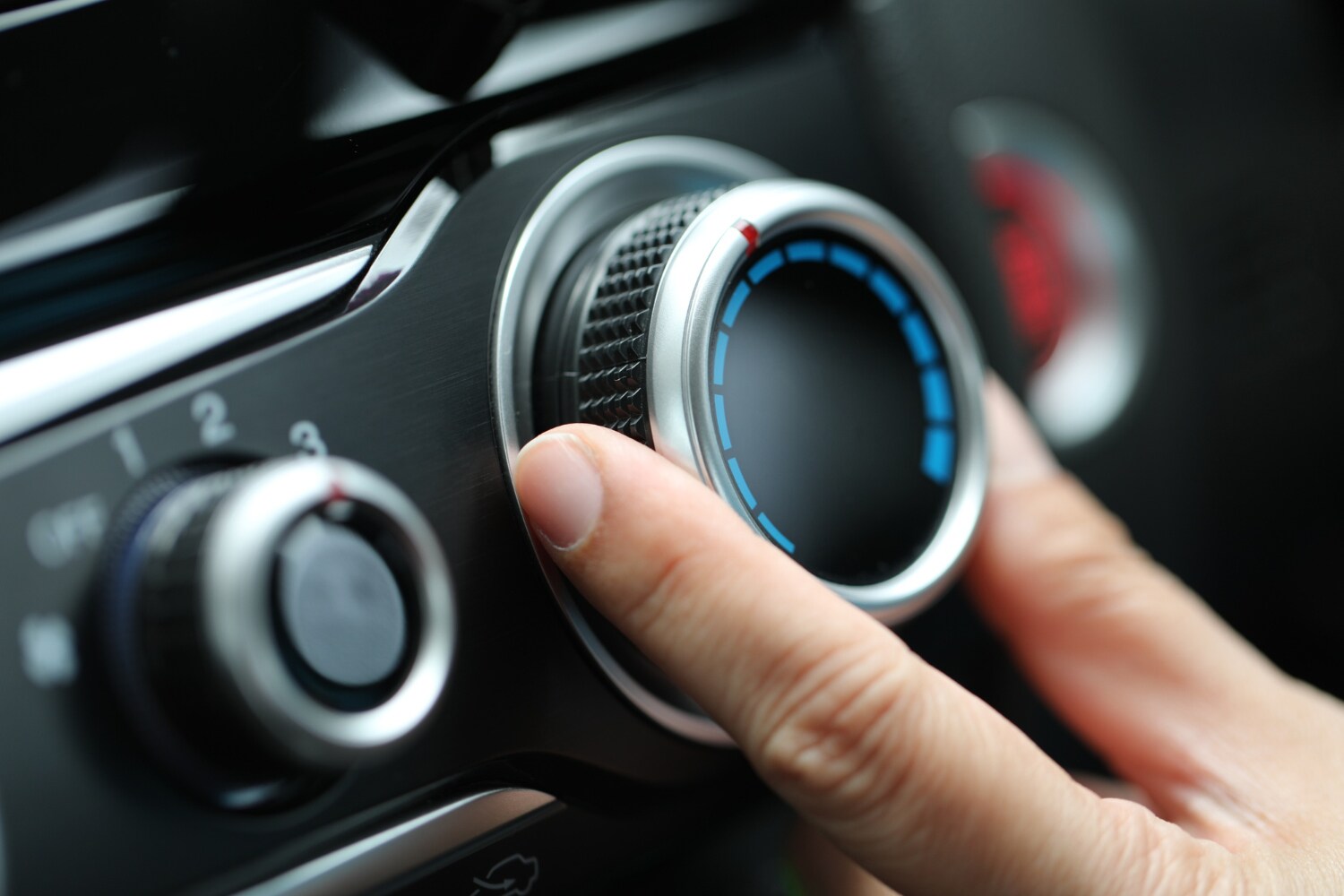 hand turning A/C knob