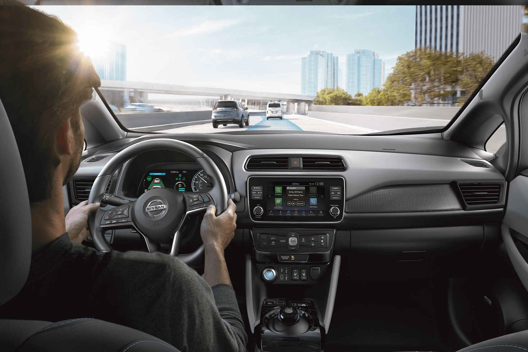 Man driving Nissan LEAF on highway.