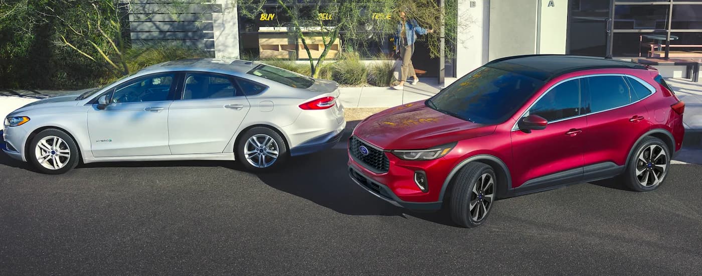 Ford%20Escape%20for%20Sale%20In%20Milan%20-%202024%20Ford%20Escape%20-%20ParkAssist.jpg A red 2024 Ford Escape for sale in Milan pulling into park beside a curb.
