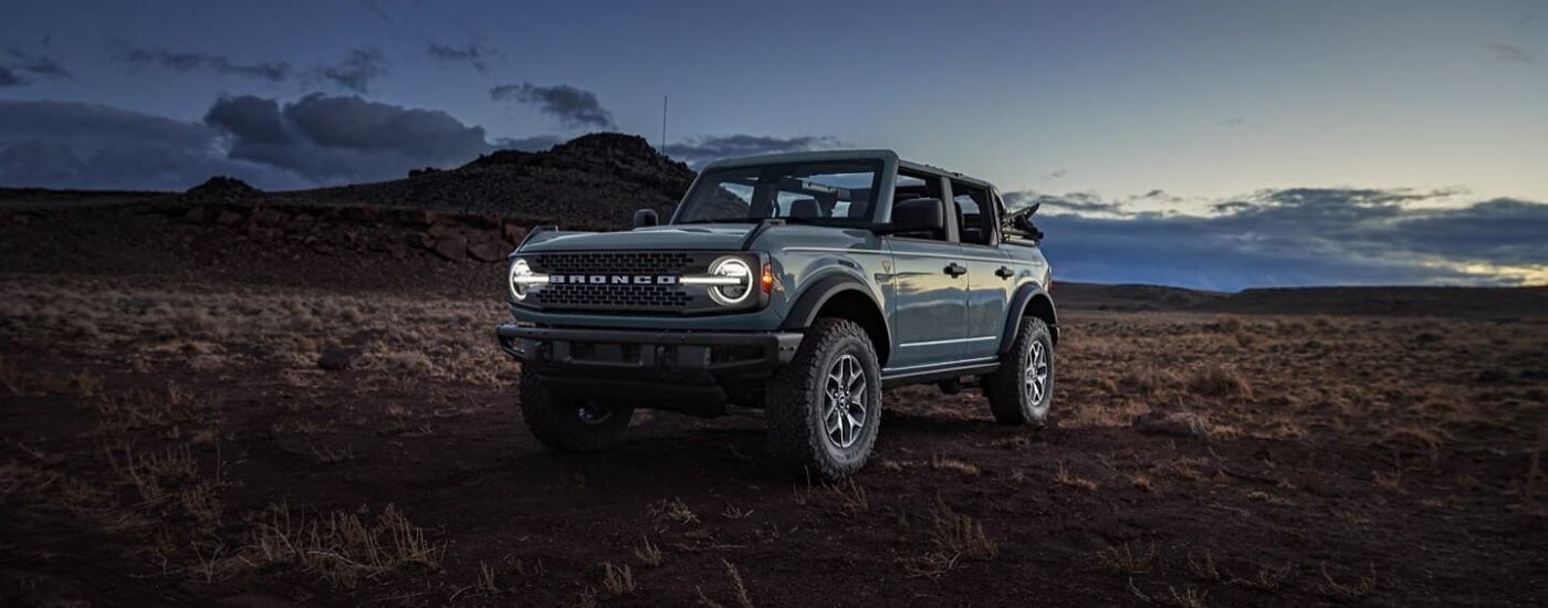Ford%20Bronco%20for%20Sale%20-%202024%20Ford%20Bronco%20Badlands%20-%20Dusk.jpg Left angled view of a grey 2024 Ford Bronco Badlands parked off-road on a field.