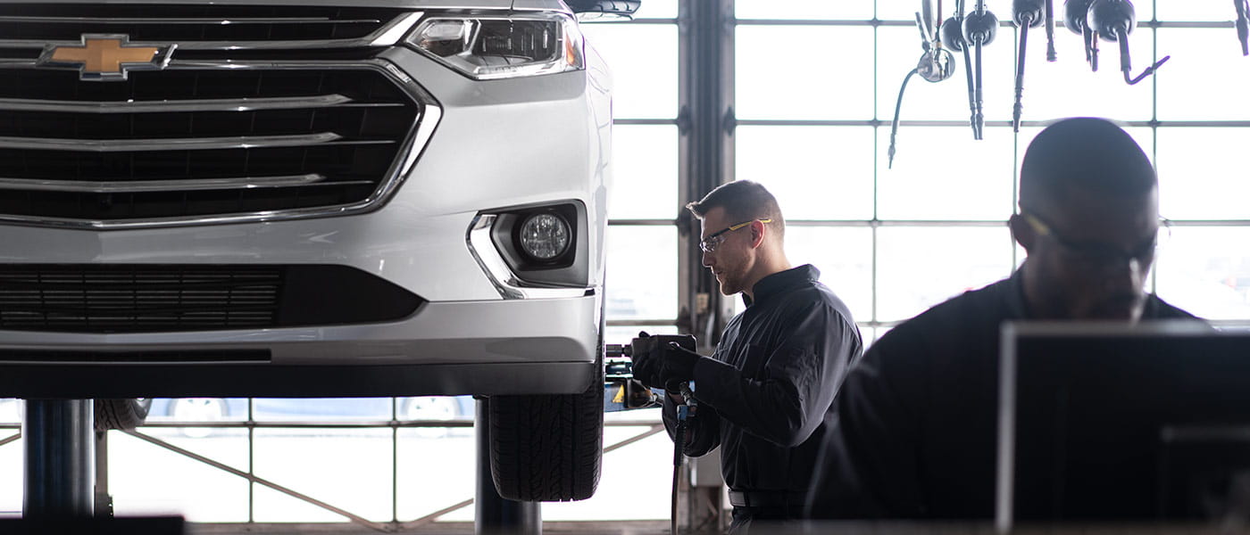 Chevy service technician Chevy service technician working on cehvy vehicle