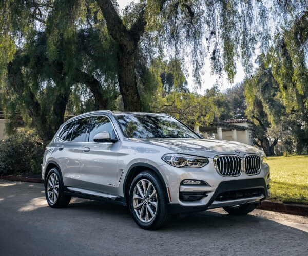 2020-BMW-X3-xDrive30i-xLine-SUV-L02 (1).jpg New BMW X3 driving down a town road