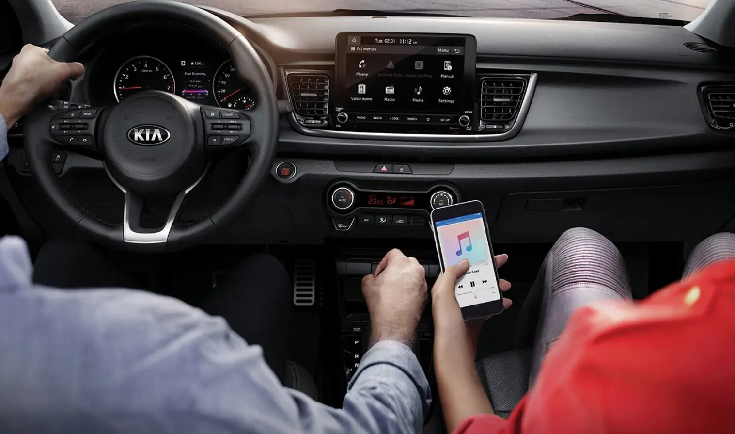 2021 Kia Rio Interior with passenger changing music via iphone 2021 Kia Rio Interior with passenger changing music via iphone