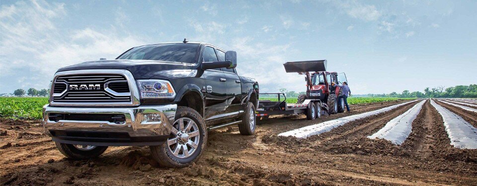 2018 RAM 2500 towing a tractor