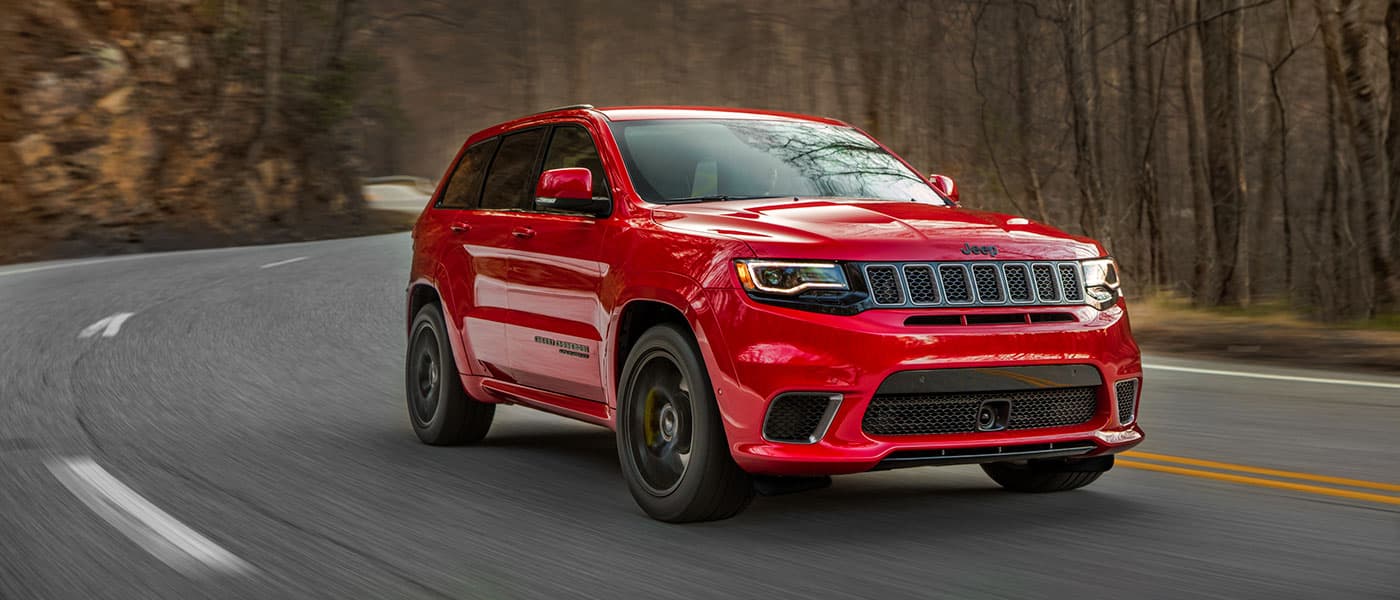 2019 Jeep Grand Cherokee Red 2019 Jeep Grand Cherokee driving down road