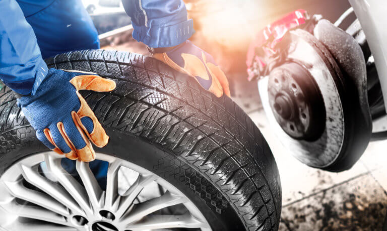 Technician replacing a tire