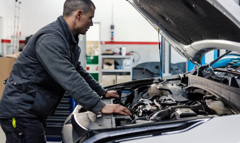 Technician looking under the hood