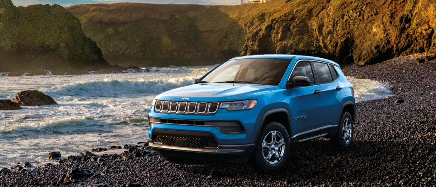 2024 Jeep Compass parked on a rocky beach