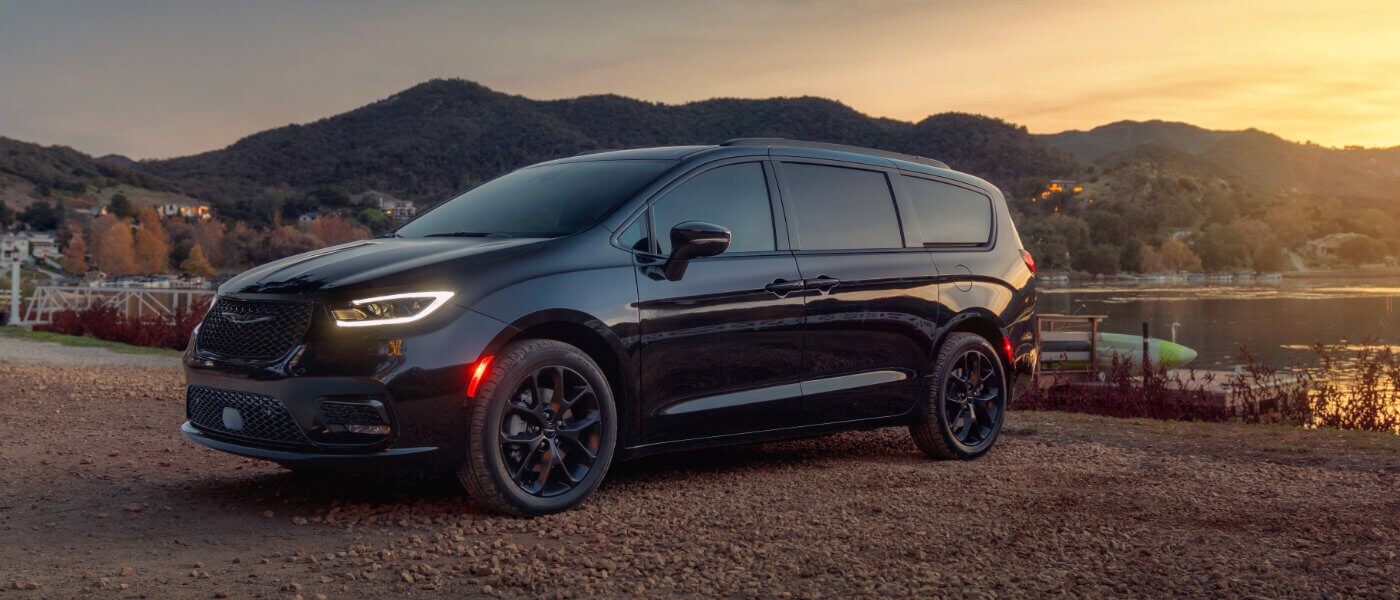 2026 Chrysler Pacifica parked by lake with lights on