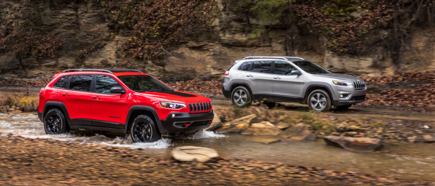 Jeep Cherokee driving through a creek