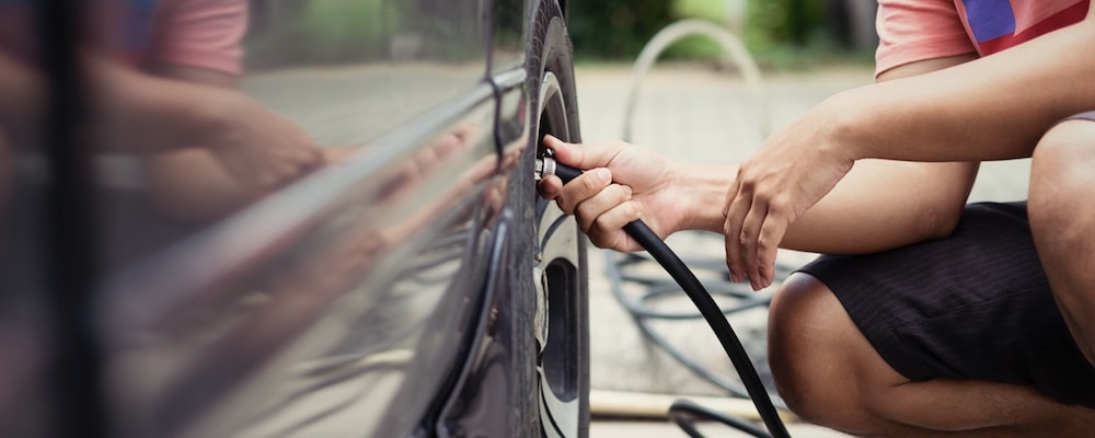Man checking tire pressure_116767146.jpg