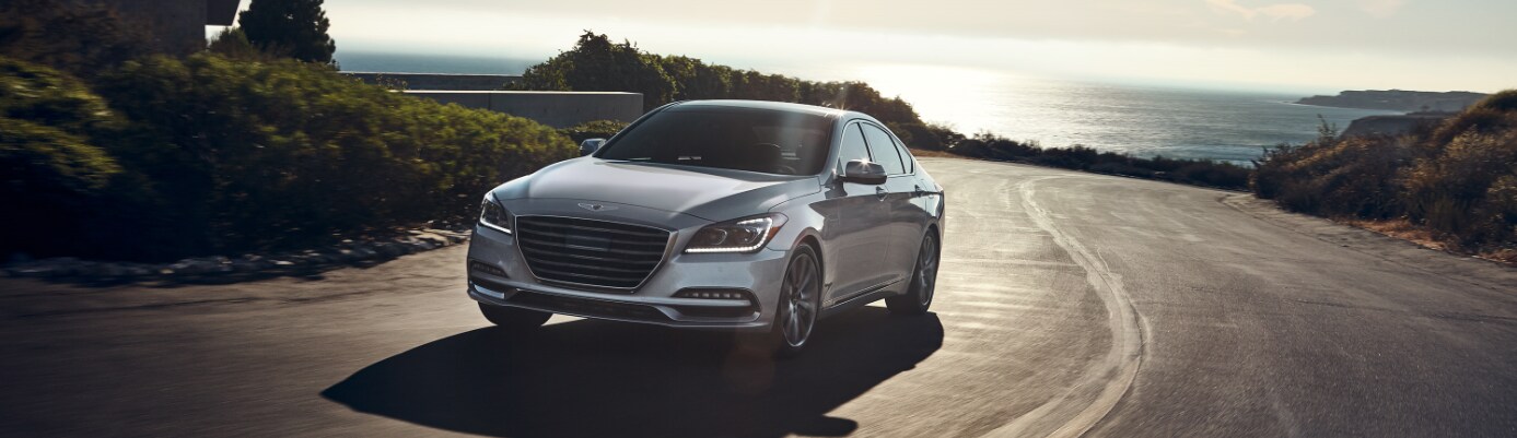 Silver Genesis G80 Front driver side view driving