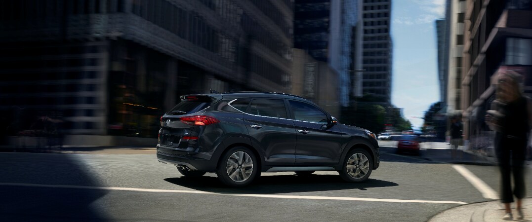 2019 Hyundai Tucson turning onto a street rear passenger vew