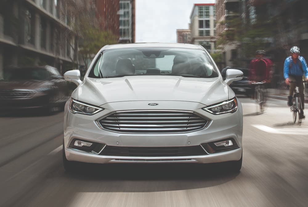 2019 Ford Fusion 2019 Ford Fusion driving down street past bikers