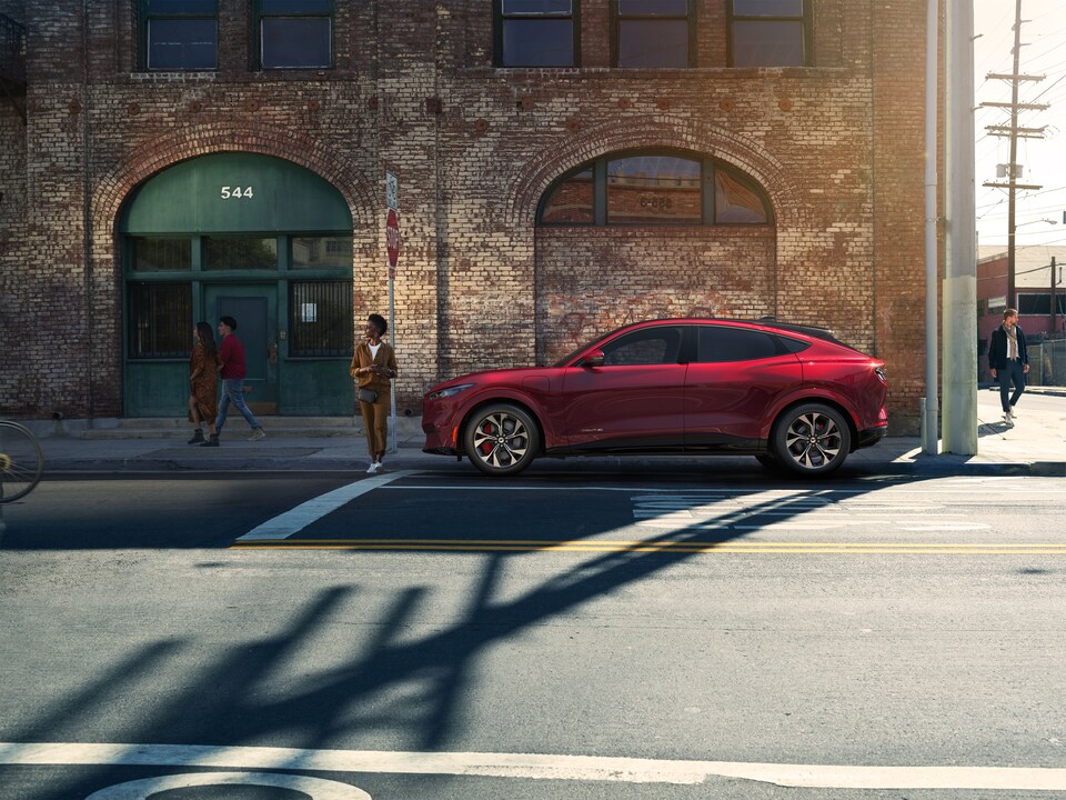 New Ford Mustang Mach-E Electric SUV Side View in Red New Ford Mustang Mach-E Electric SUV Side View in Red