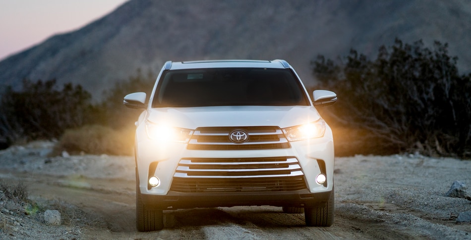 New Toyota Highlander SUV Front Grille View With Headlights On