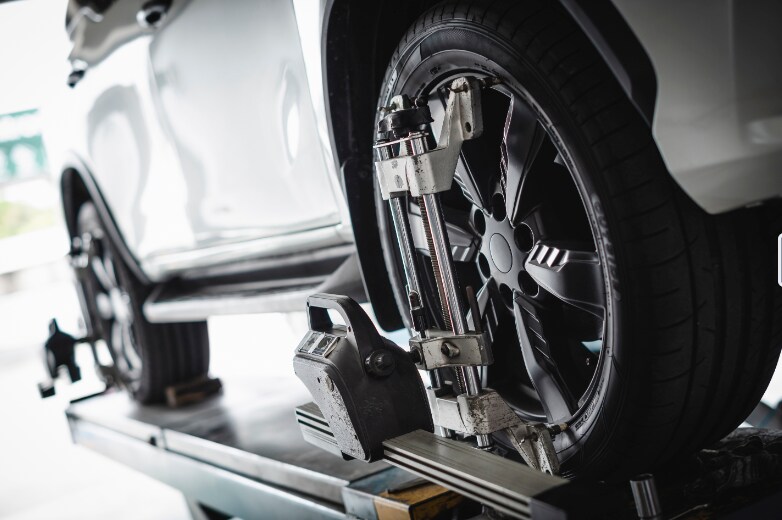 A car undergoing wheel alignment service A car undergoing wheel alignment service