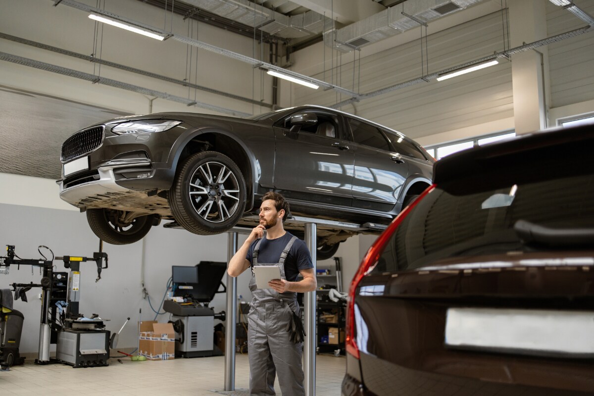 An engineer examining vehicles for routine maintenance An engineer examining vehicles for routine maintenance