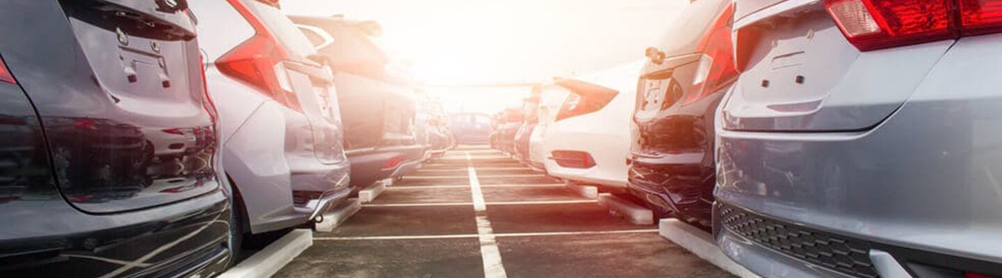 What You Should Look for When Buying a Used Vehicle Lineup of used vehicles parked on dealership lot