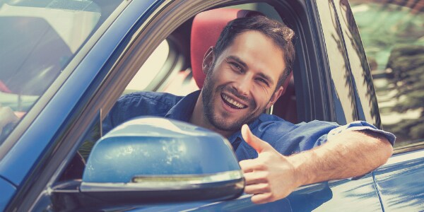 A happy driver giving a thumbs up A happy driver giving a thumbs up