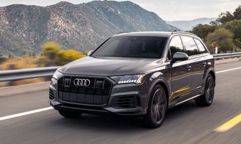 2021 Audi Q7 in grey driving along mountain ranges