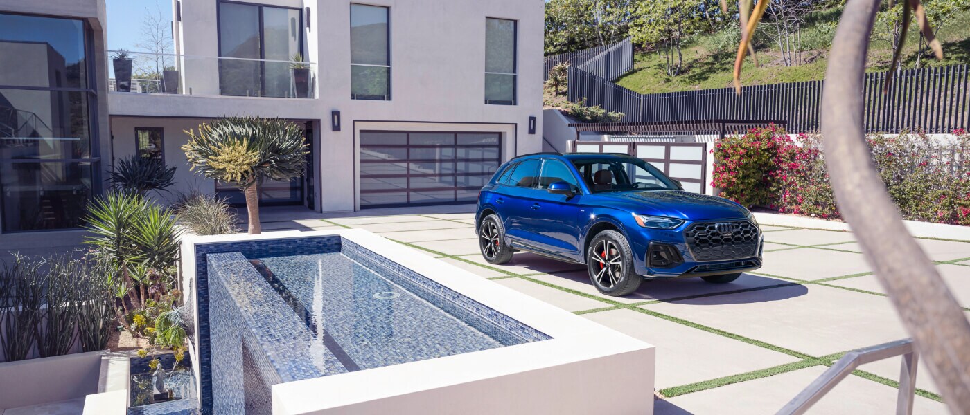 2025 Audi Q5 Exterior Parked In Driveway By House with Waterfall