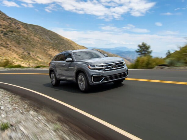 2020 VW Atlas Cross Sport A silver 2020 VW Atlas Cross Sport driving down a coast
