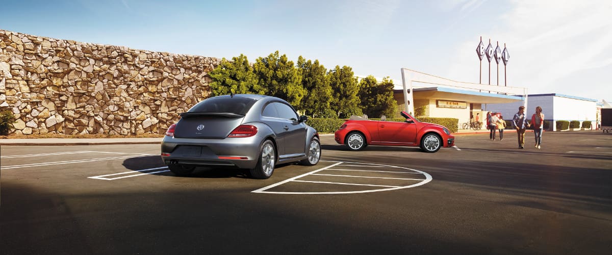 2019 Volkswagen Beetle A 2019 Volkswagen Beetle and Beetle Convertible parked outside of a bowling alley