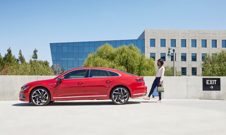 2022 VW Arteon Exterior Side View With Woman Using Trunk Pedal