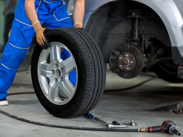 Volkswagen Service A service technician putting a new tire on a vehicle