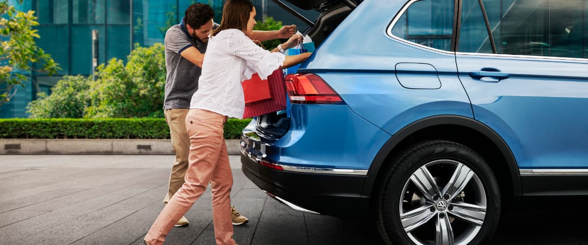 2019 Volkswagen Tiguan A couple putting bags into the back of their Volkswagen Tiguan