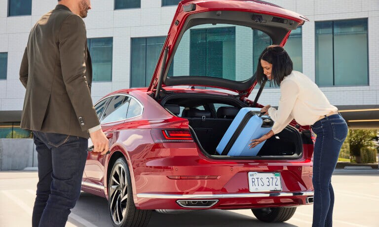 2022 VW Arteon Exterior With Woman Loading Luggage Into Trunk