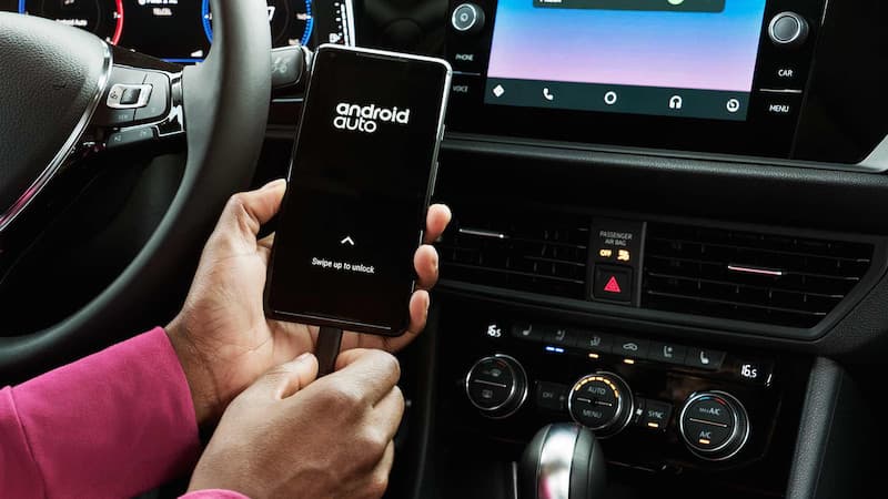 2019 Volkswagen Jetta Technology A person pluging their phone in with android auto
