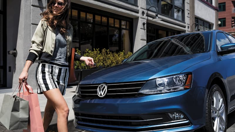 2017 VW Jetta A woman walking to her 2017 VW Jetta